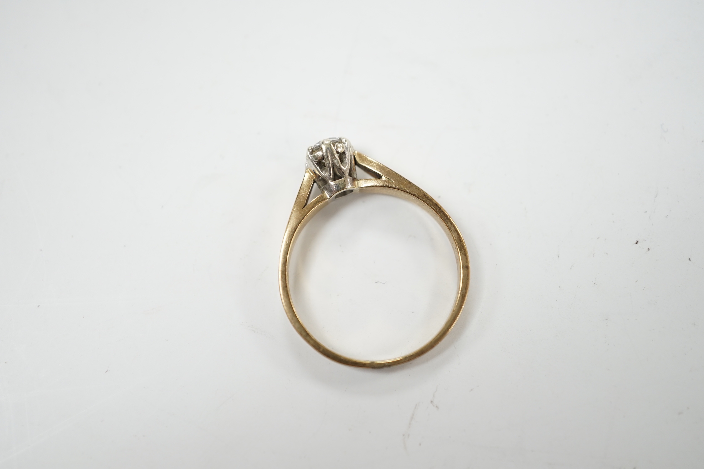 A yellow metal and solitaire diamond set ring, size N/O, gross weight 2.4 grams.